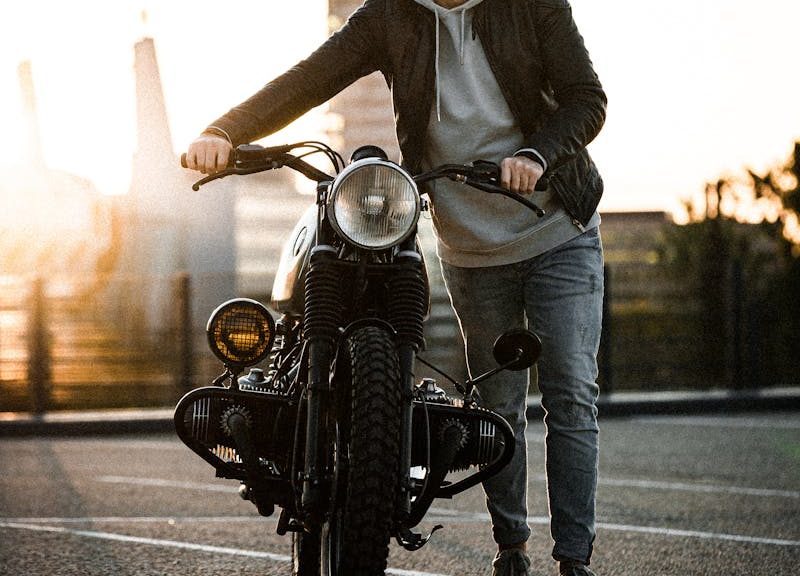 A Man Showing His Bike In A Parking Area