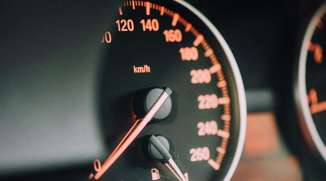 closeup photo of black analog speedometer