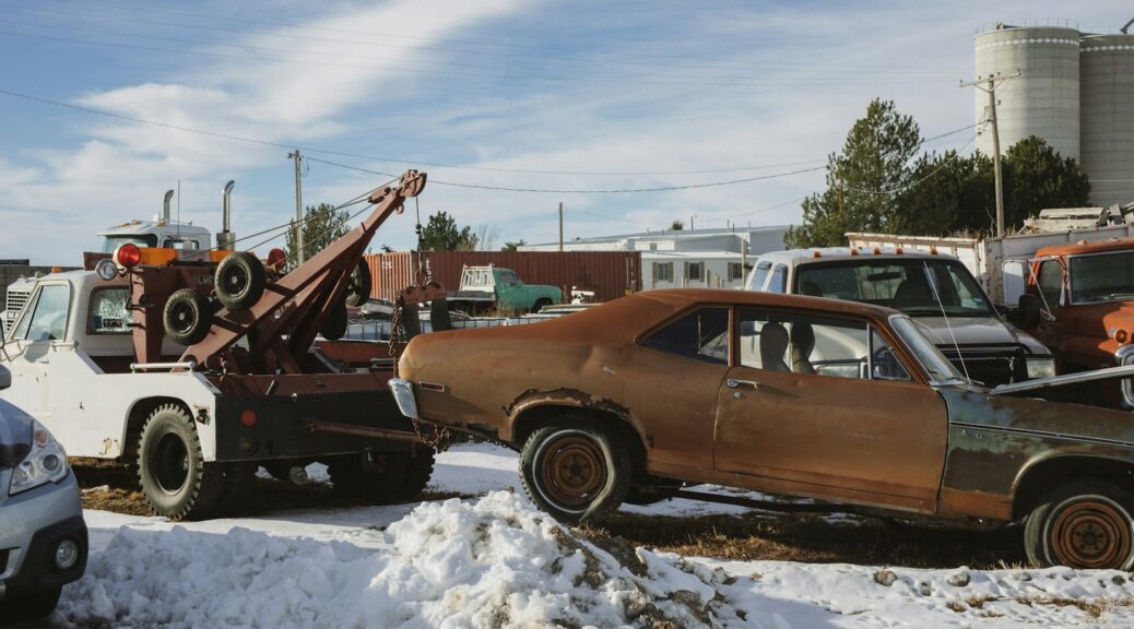 brown and white vintage car on snow covered ground during daytime