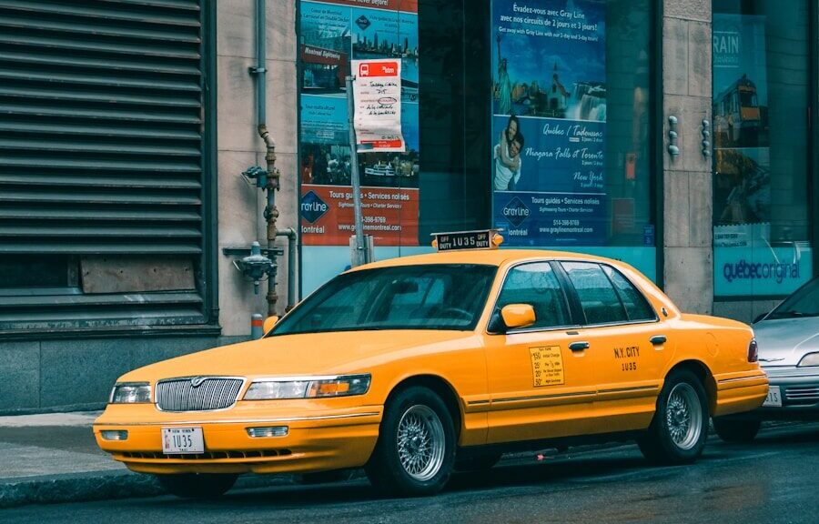 yellow taxi cab on street during daytime
